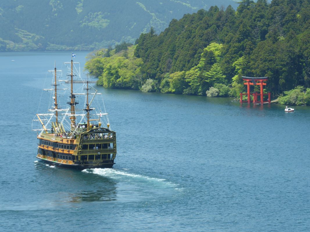 A boat and a Shinto arch on Lake Ashi Hakone Japan